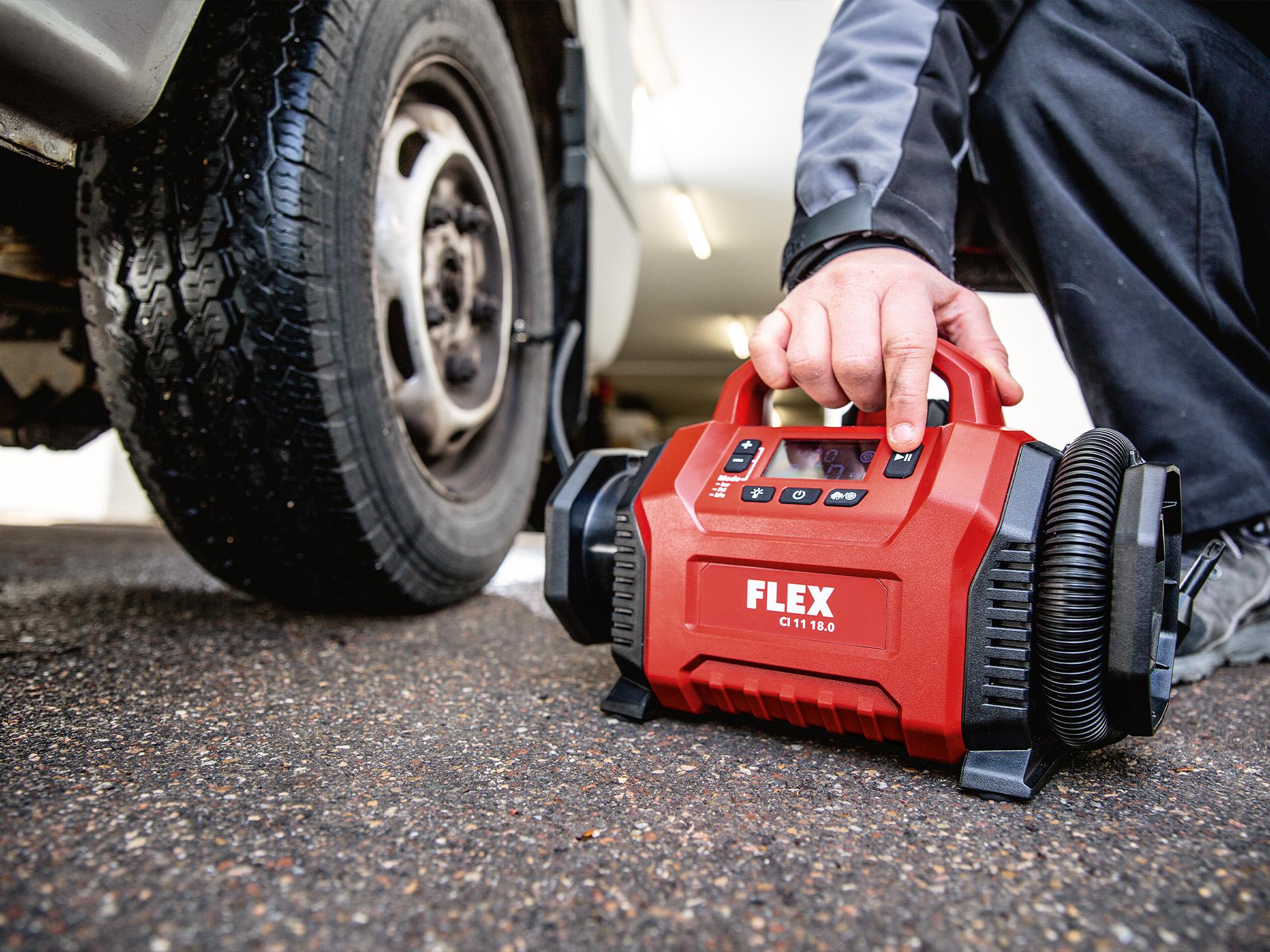 Checking the air pressure of car tyres with a battery-powered compressor